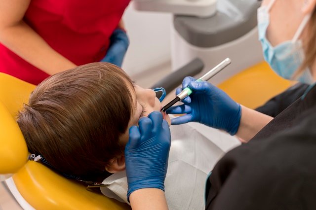 dentist-cleaning-child-s-teeth