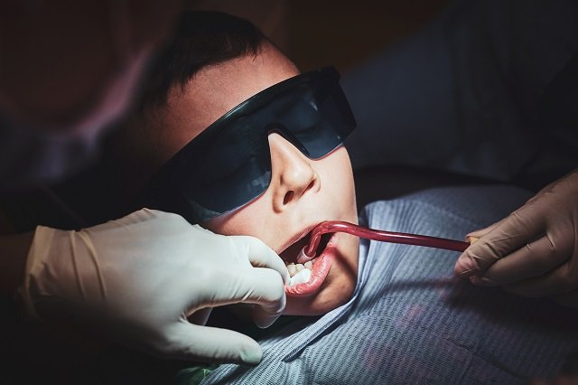 Process of dental operation for little boy